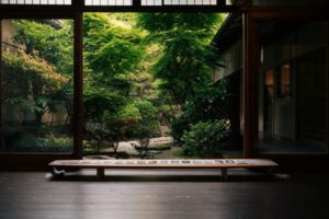 A serene view of a lush Japanese garden from a traditional Kyoto home, capturing natural beauty and cultural elegance.